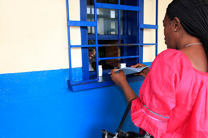{A woman visits the pharmacy at Hopital Methodiste in Dabou, Cote D'Ivoire. Photo Credit: Fabrice Duhal}